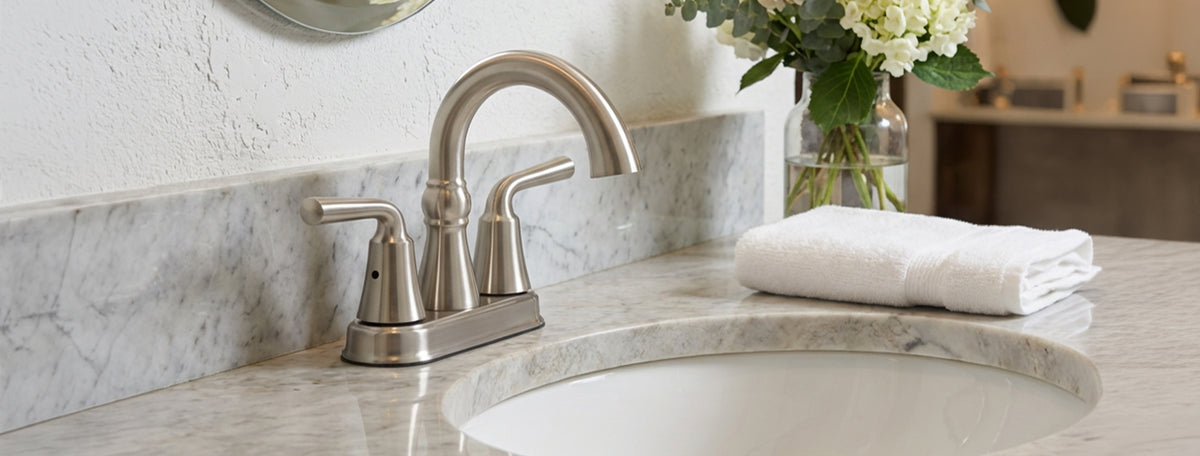 Bathroom sink with faucet and decorative flowers on a countertop